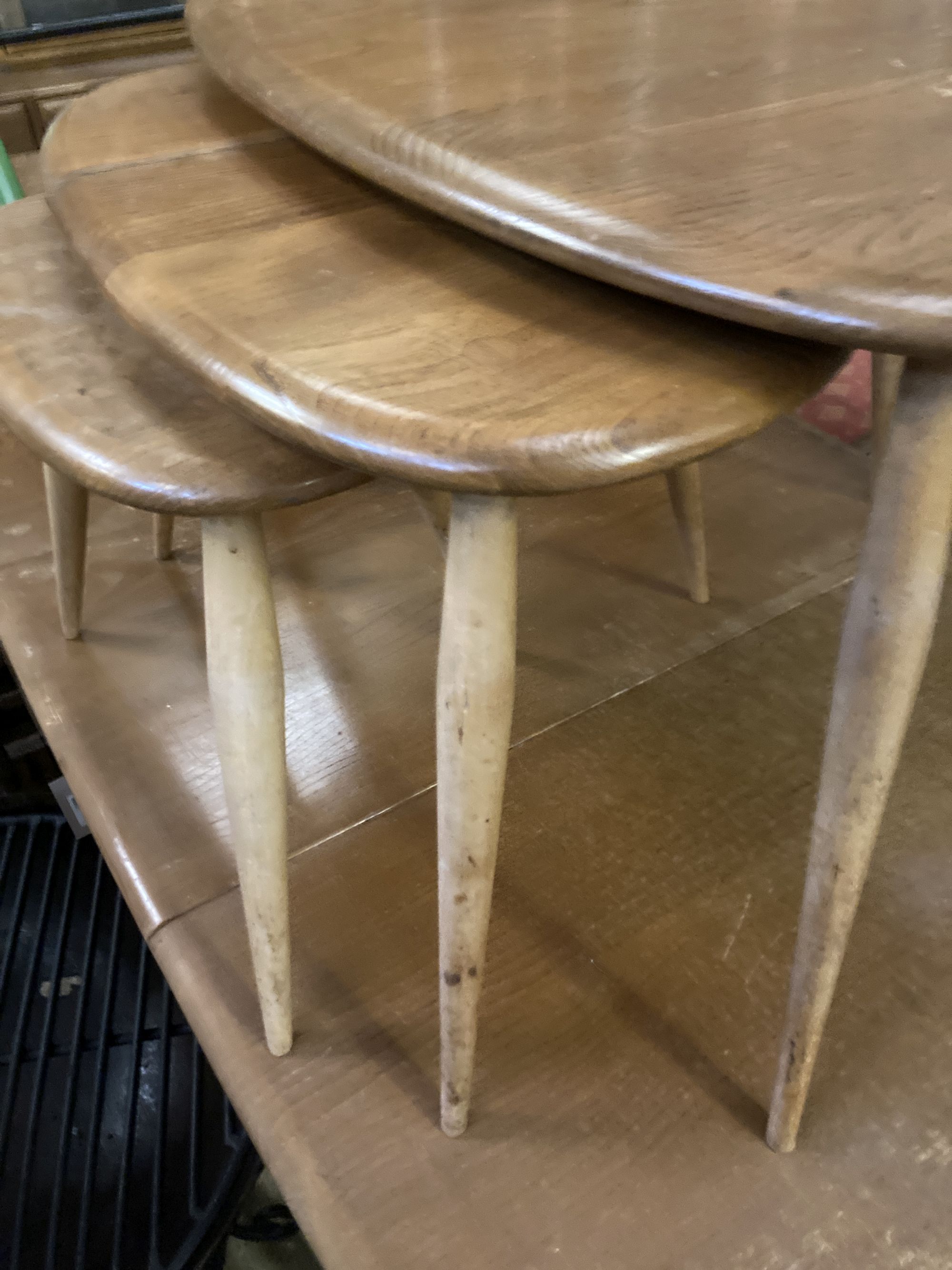 An Ercol nest of three Pebble tables, width 64cm depth 42cm height 40cm